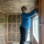 Gerry installing the glasswool batts for more insulation.